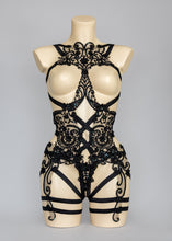 Load image into Gallery viewer, Black baroque lace bodycage, lace front panel in a gothic style with black straps and lace running down the thighs with garter straps.
