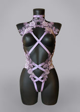 Load image into Gallery viewer, Pretty lilac lace embellished with sequins and beads. The lace pieces are arranged around the chest with an open cup style and down the tummy in a hi leg style. Lilac elasticated straps cross cross at the front and fasten at the back.
